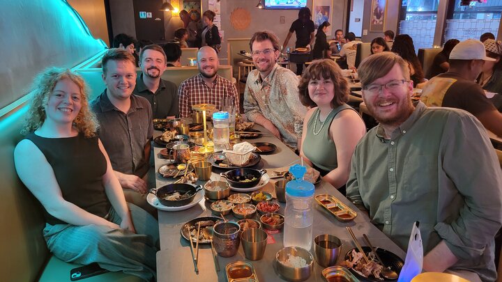 NAG Reunion Dinner with Korean dishes and drinks under warm lighting.